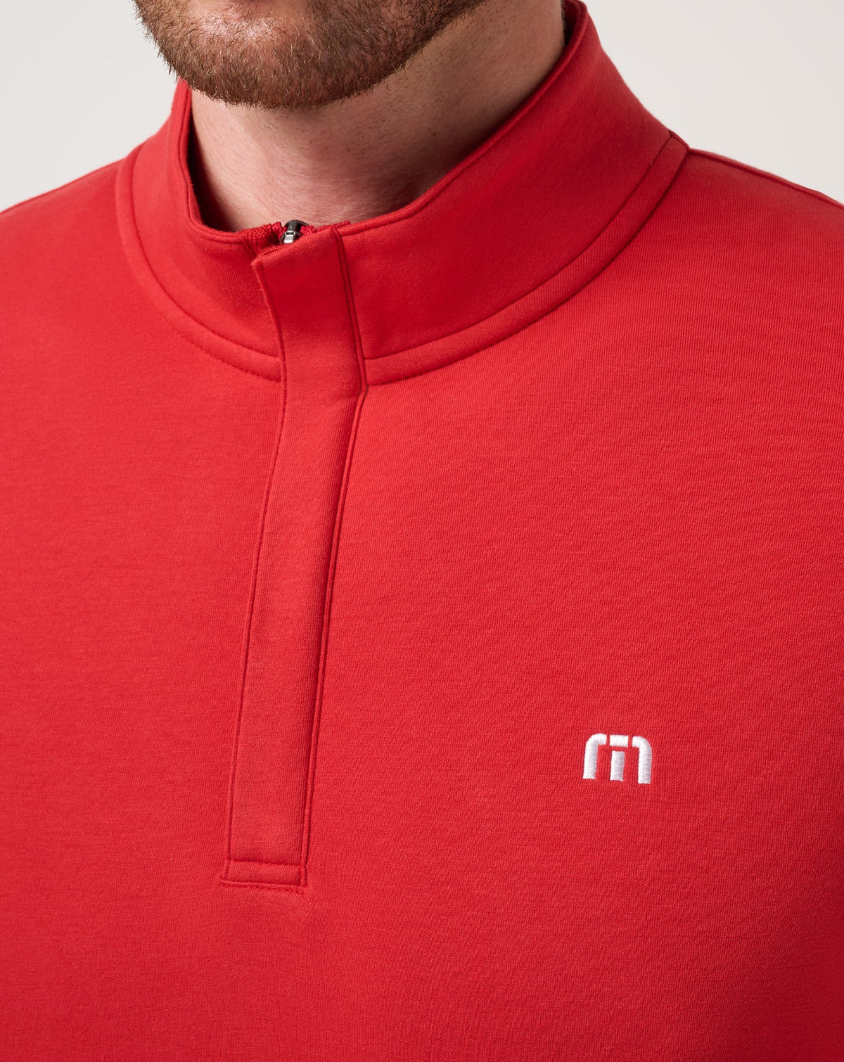 Travis Mathew red quarter-zip pullover with mock neck and embroidered logo