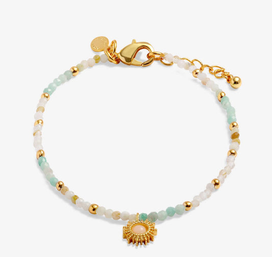 Beaded bracelet with mint and white stones, gold beads, sun charm, and lobster clasp