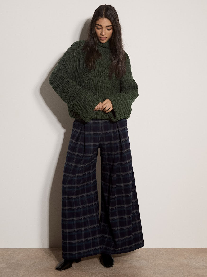Chunky cable knit dark green turtleneck jumper with ribbed sleeves and hem