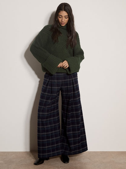 Chunky cable knit dark green turtleneck jumper with ribbed sleeves and hem