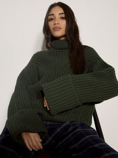 Apricot chunky cable knit dark green turtleneck jumper with wide cuffs