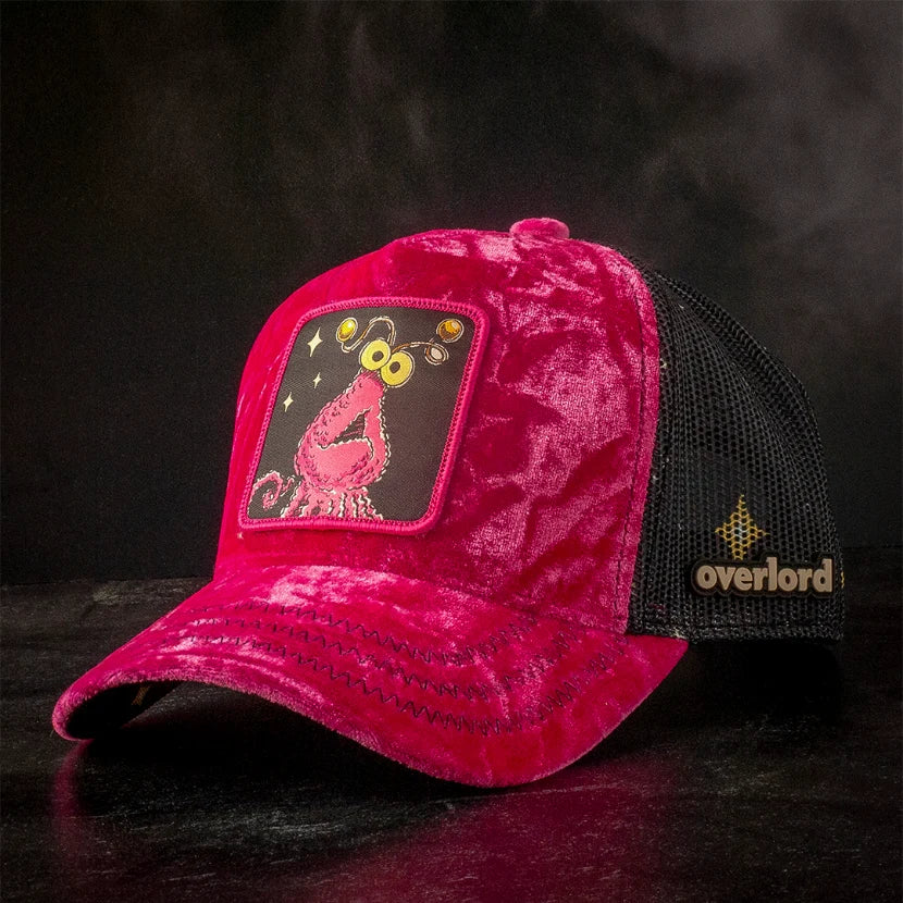 Pink crushed velvet trucker hat with Yip-Yip monster patch and black mesh back