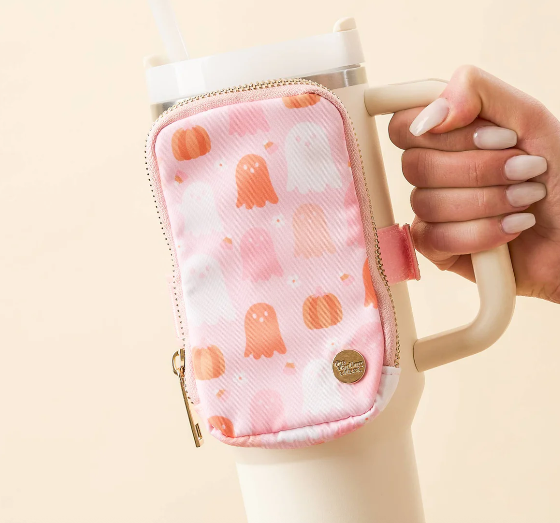 Pink ghost and pumpkin print zippered pouch attached to a cream tumbler handle