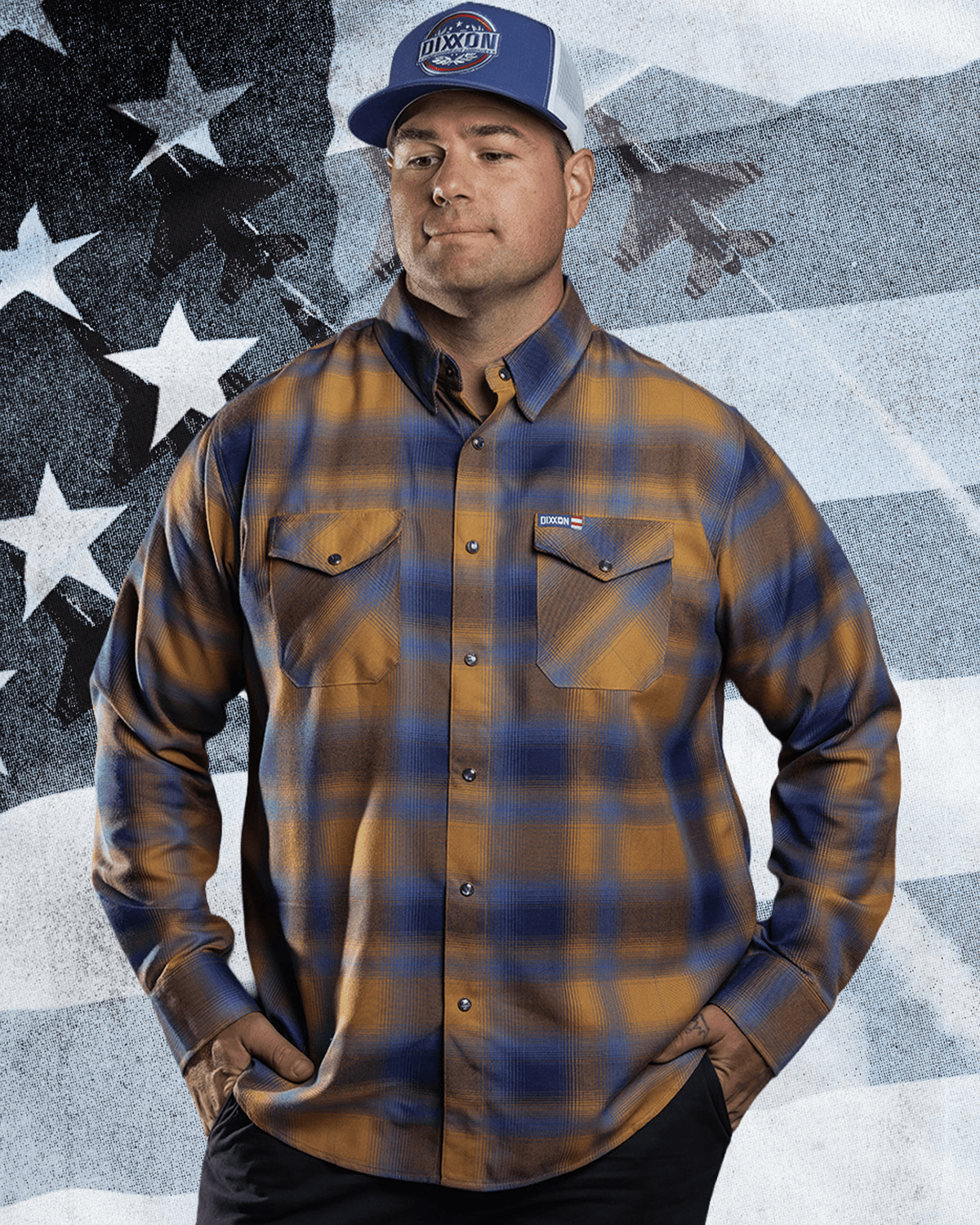 Man wearing Dixxon flannel shirt in gold and navy plaid with matching trucker hat