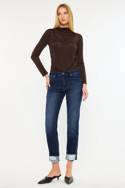 Model wearing KanCan mid rise skinny straight jeans with cuffed hem and brown top