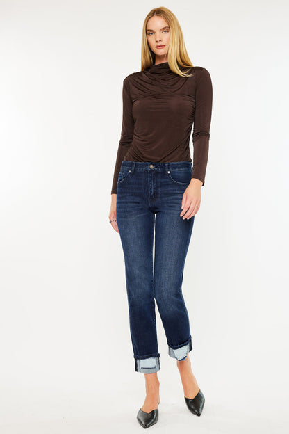 Model wearing mid rise skinny straight jeans with cuffed hem and dark wash denim