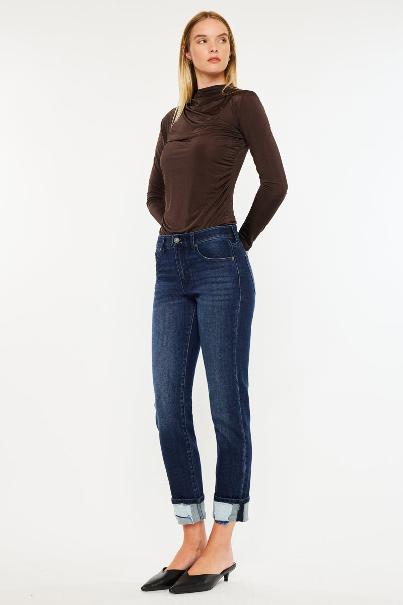 Model wearing mid rise skinny straight jeans with cuffed hem and dark wash