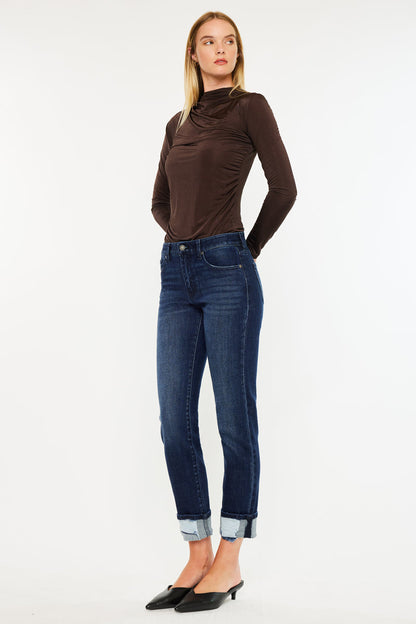 Model wearing mid rise skinny straight jeans with cuffed hem and dark wash