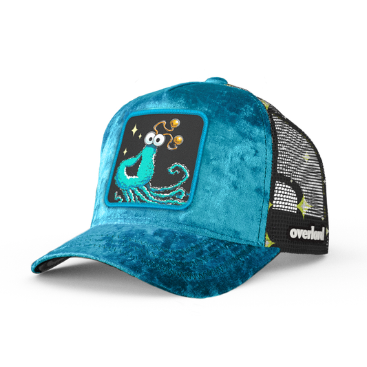 Teal velvet trucker cap with embroidered Yip-Yip alien patch on black background
