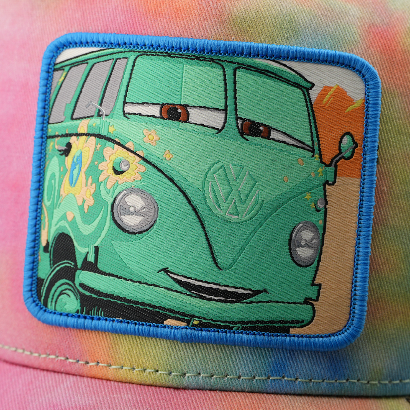 Close-up detail of Fillmore VW bus patch on tie-dye Cars Pixar cap