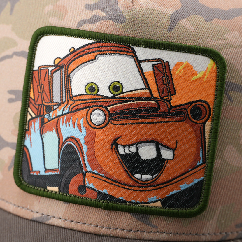 Close-up detail of Tow Mater embroidered patch on camouflage trucker cap