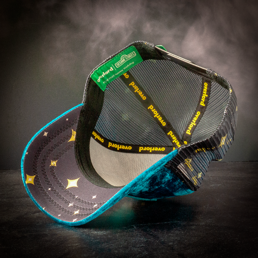 Interior underside view of a snapback hat showing starry brim lining and branded sweatband