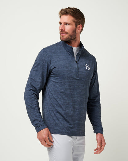 Man wearing Travis Mathew quarter-zip pullover with New York Yankees logo on chest